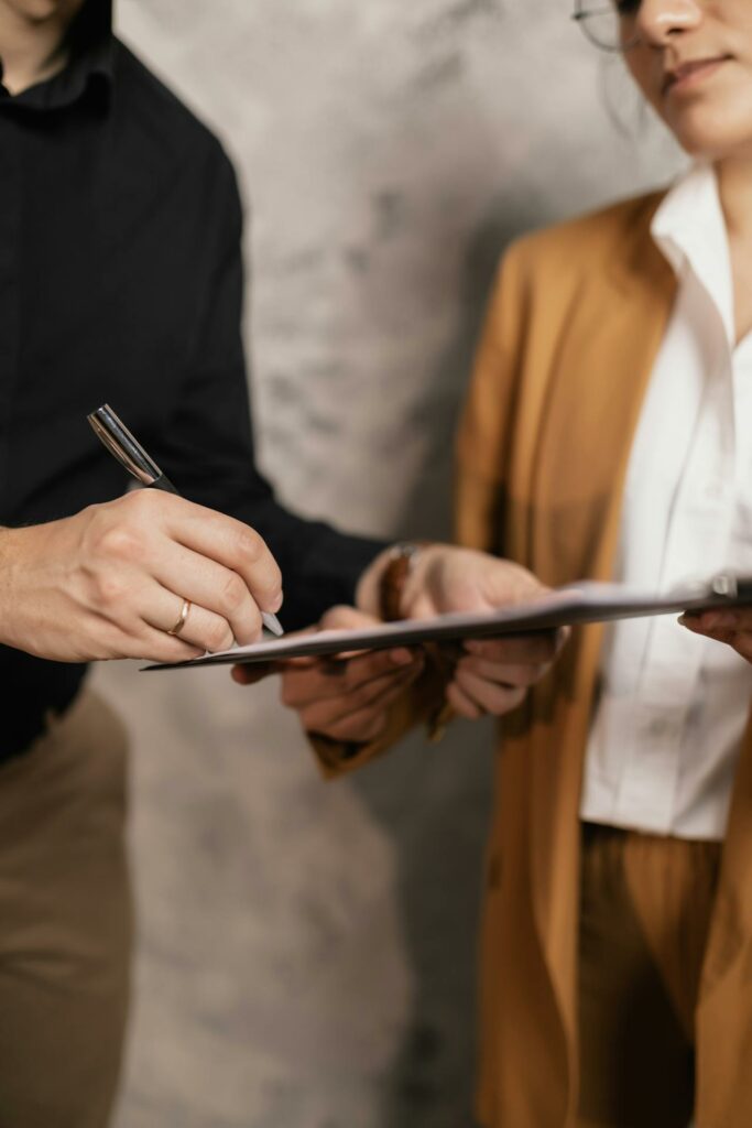 A Person Signing a Document