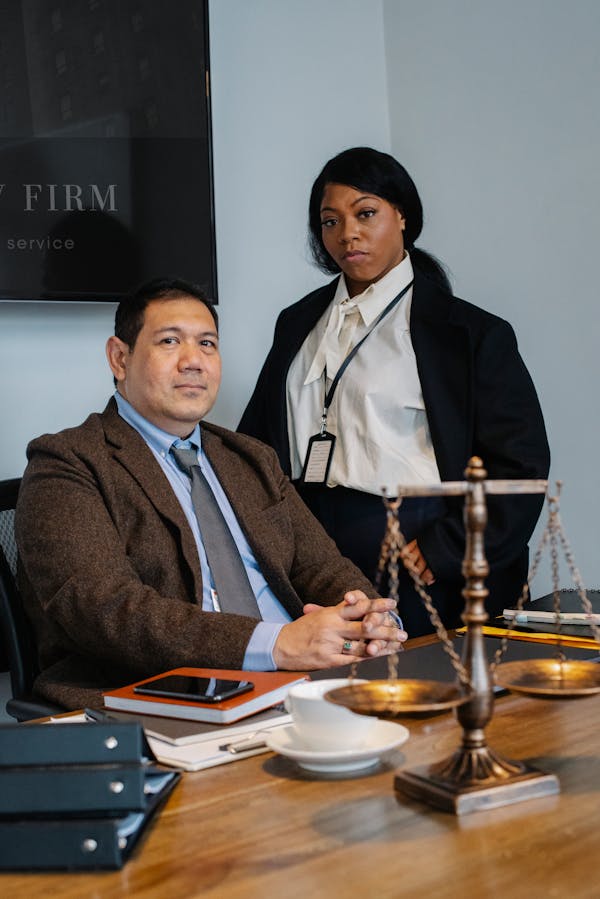 Diverse Lawyers near Wooden Table